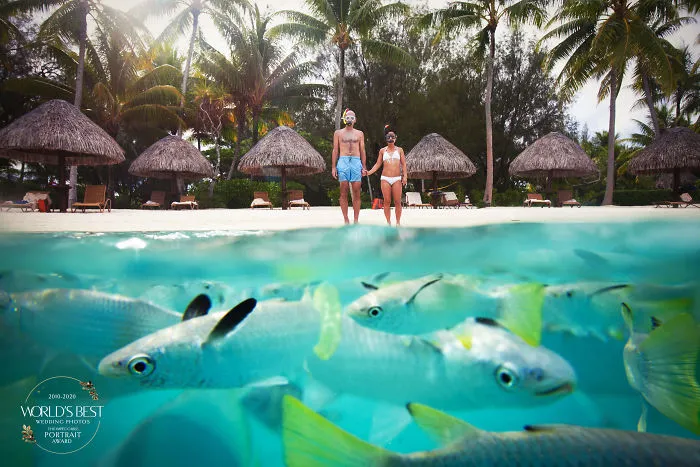 This Colorful, Goofy, Lovable Photo Of A Couple On A Beach In Bora Bora.
