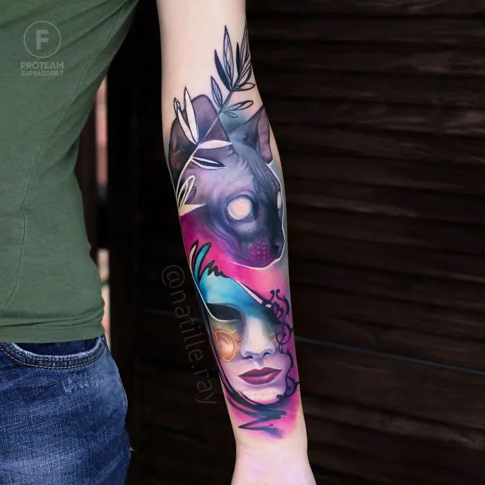 Colorful and bright animal tattoo featuring a mystical wolf and abstract face design on a person's forearm.