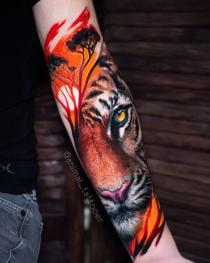 Colorful and bright tiger tattoo on a forearm featuring vibrant trees and intense colors.