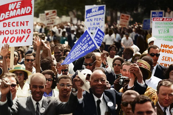 Leaders Of The March Leading Marchers Down The Street