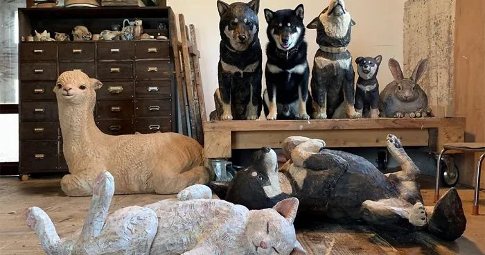 Cute Video Shows Dog Trying To Blend In Between Animal Sculptures