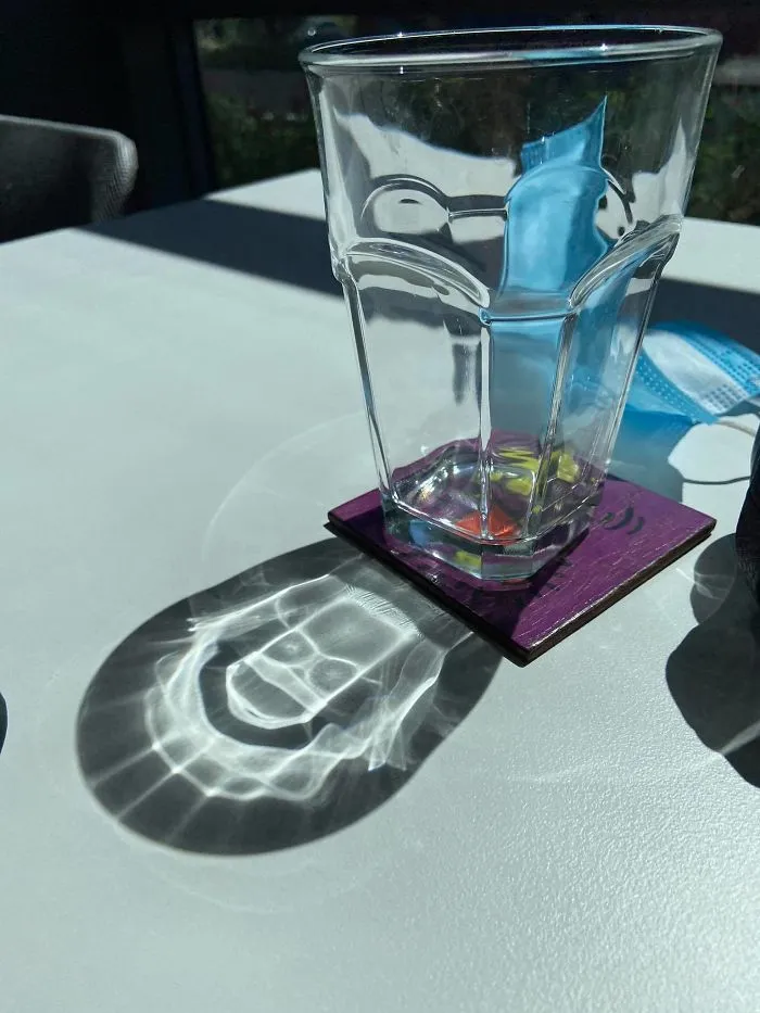 Sun's Reflection On My Drinking Glass Creates Bart Simpson’s Skull