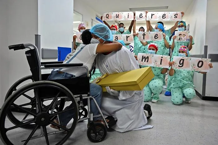 Jefferson Riascos (Center) Is Embraced By Diana Paola Angola (Left) Who Recovered From Covid-19, After Asking Her To Marry Him At The Versalles Clinic In Cali, Colombia