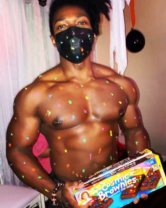Man dressed up as a cosmic brownie, showing off unique Halloween costumes.