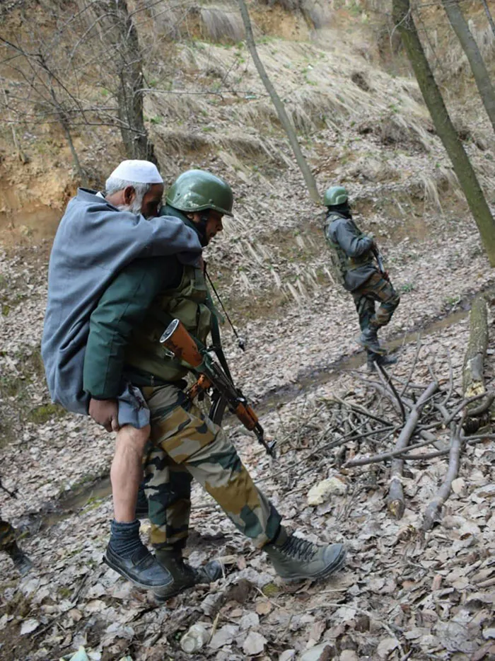 An Old Man While Working In A Field Twisted His Ankle And Was Carried To His Home In The Village Over A Kilometer By Indian Army Troops