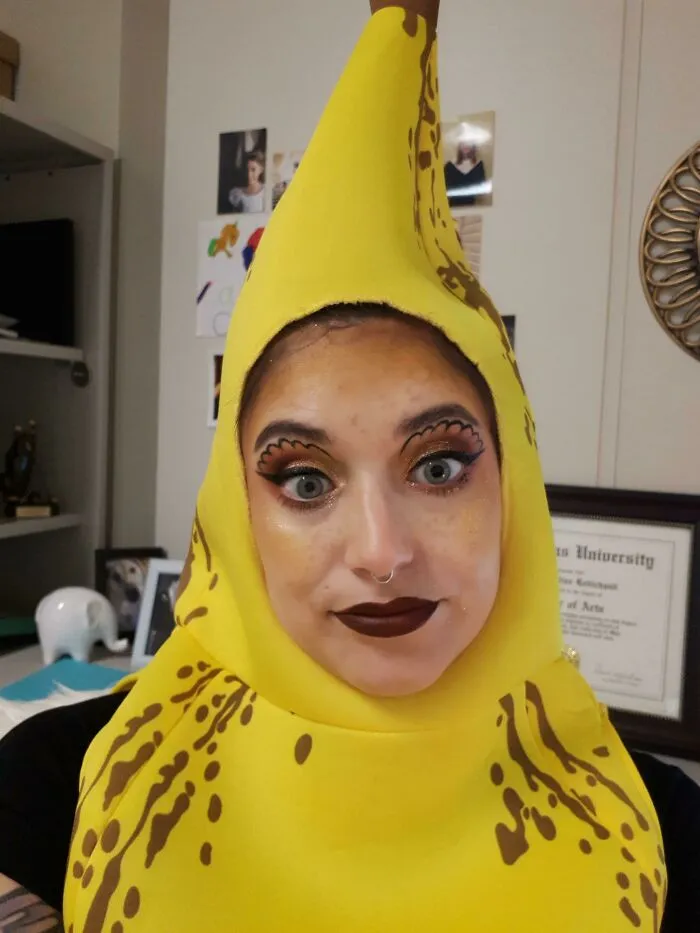 Close-up of a woman wearing a banana costume, displaying funny Halloween costumes.