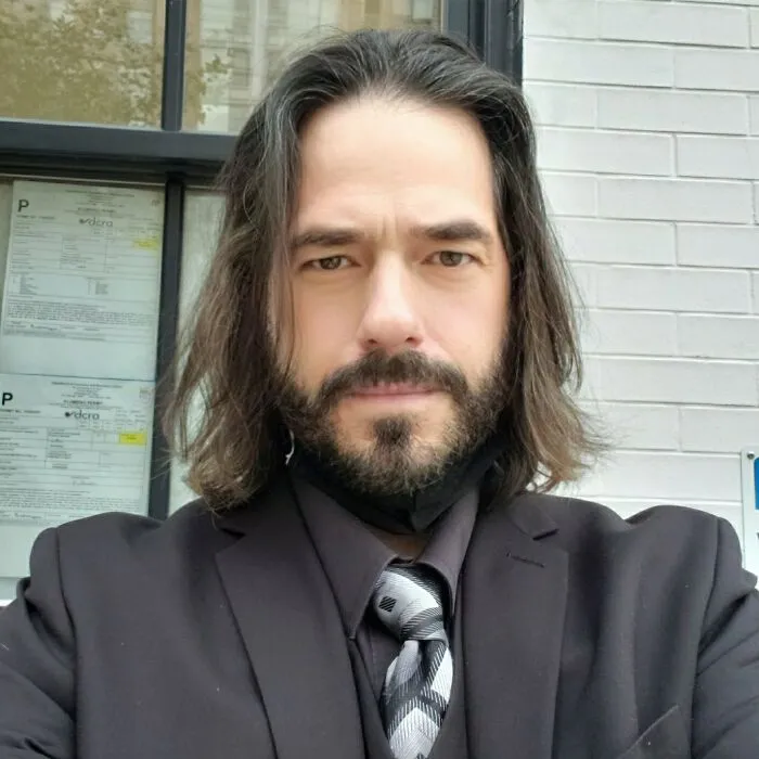 Man wearing a John Wick suit as one of the best Halloween costumes