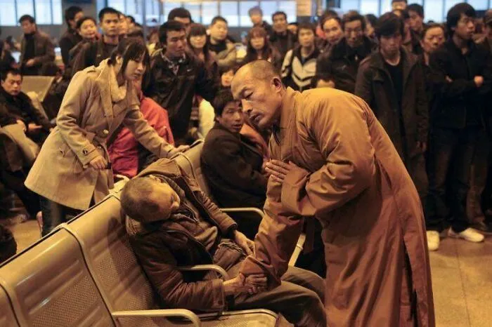 A Monk Prays For An Elderly Man Who Had Died Suddenly While Waiting For A Train In China.
