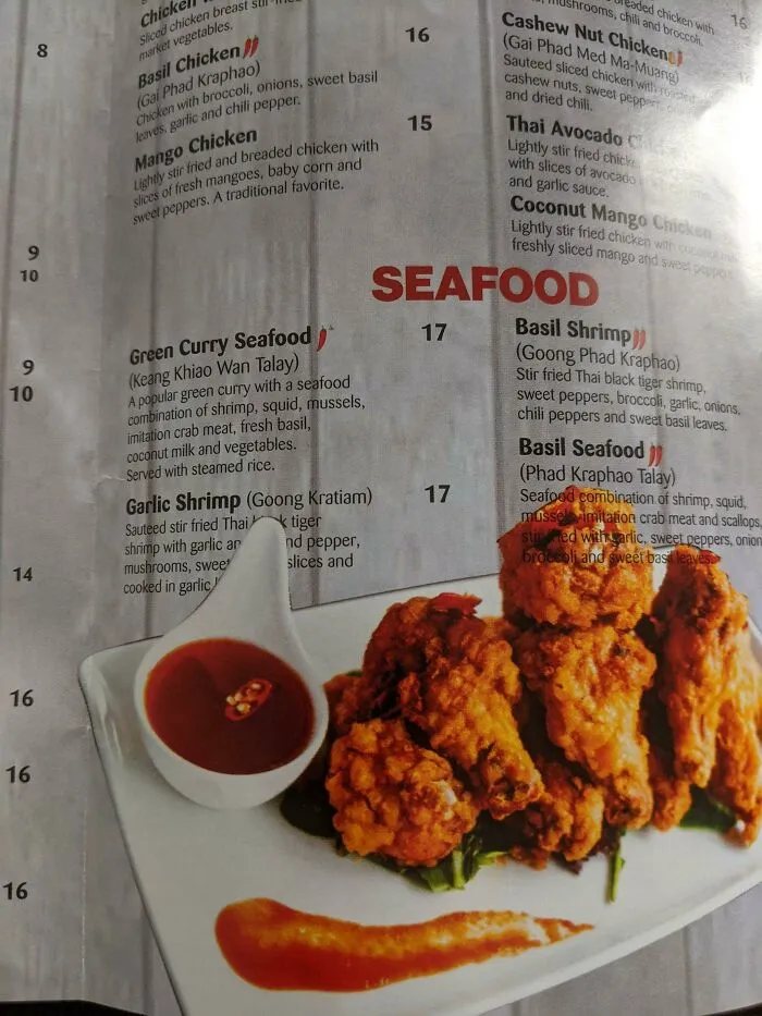 I'm Impressed That This Thai Menu Has Text Cropping Both Over And Under The Image