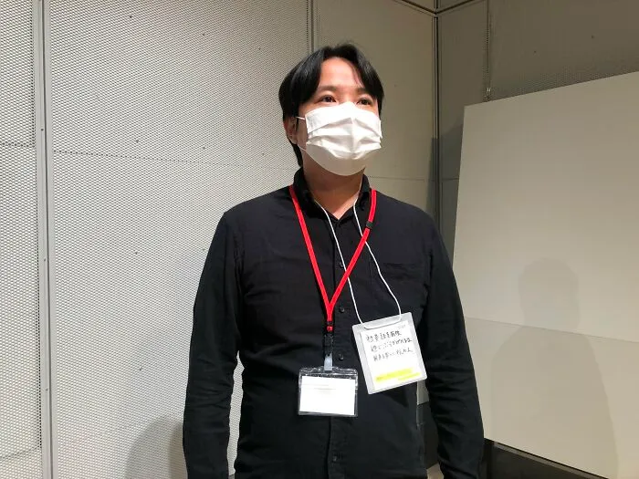 "An office worker whose lanyard name card has flipped over"