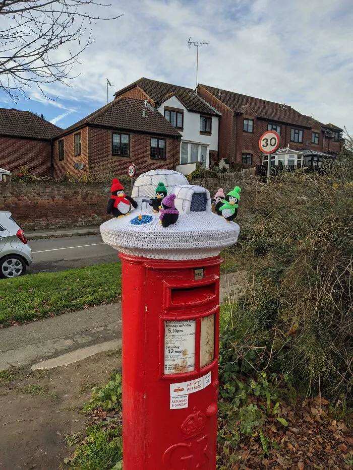 Every Year On December 1st Someone Puts A Knitted Hat On Top Of The Post Box At The End Of My Road. This Year's Is The Best So Far