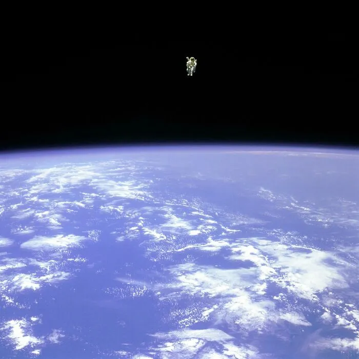 Astronaut floating above Earth, showcasing the rare and unseen side of space exploration.