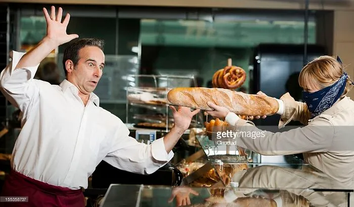 Woman Is Robbing Bakery With A Baguette