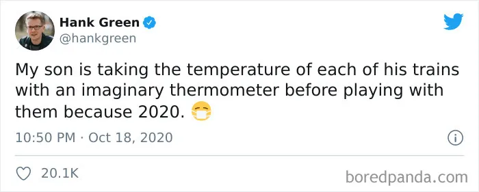 Tweet by Hank Green humorously describing a child pretending to take the temperature of toy trains, showing kids are not born smart.