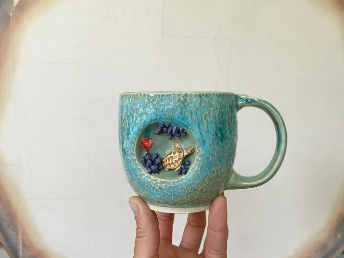 These 31 Brilliant Mugs Have Small Side Nooks Where Tiny Animal Sculptures Live