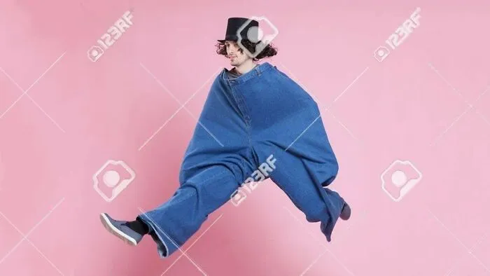 Man Frolicking With Large Denim Pants