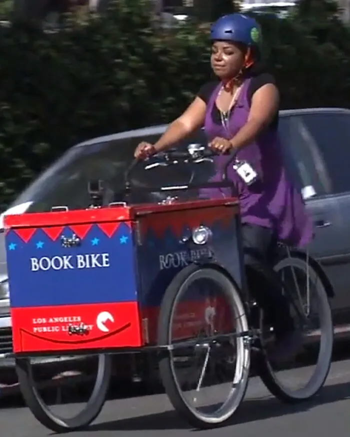 When It's A Pandemic And This San Pedro Librarian Pedals With Books On A Mission To Gather Young Readers