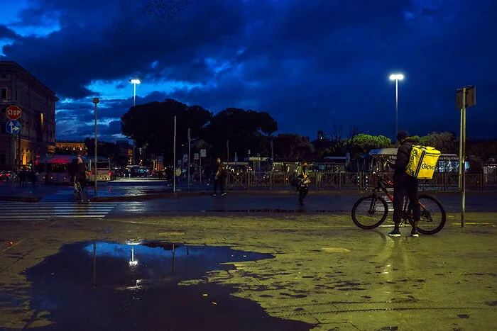 Day 4: Another Blue Picture. Maybe I’m In A Sort Of “Blue Period”, Blue As The Color, Not The Mood, I Guess. A Few People In The Streets, But As Always In The Last Year, It’s Normal To Meet A Rider Waiting To Deliver Food.