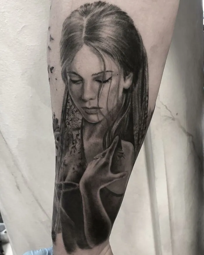 Black and gray realism tattoo of a woman on a forearm by Swedish artist.