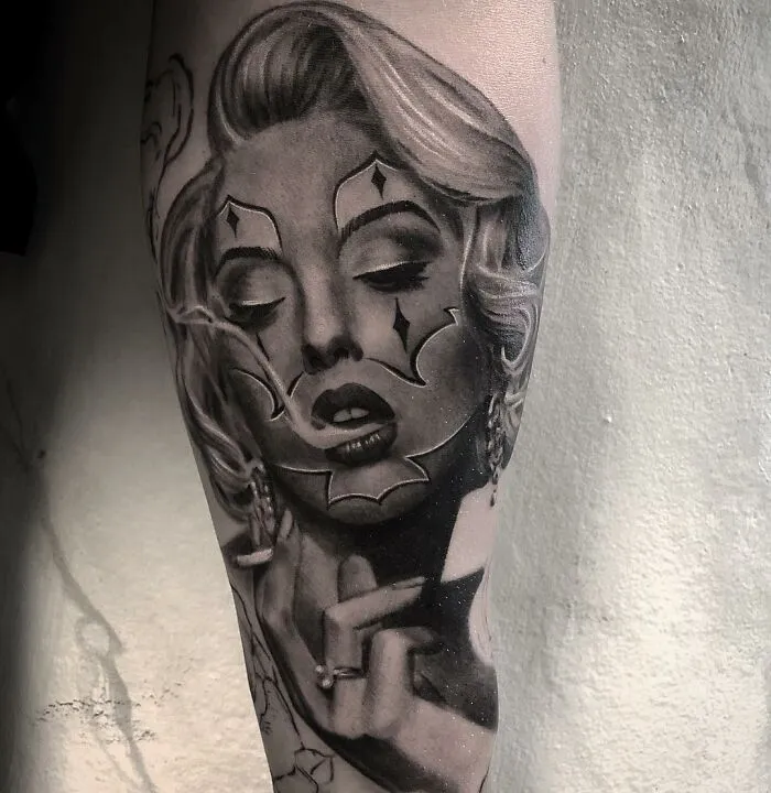 Tattoo of a woman's face in black and gray realism style by Swedish artist, featuring elegant detail and shading.
