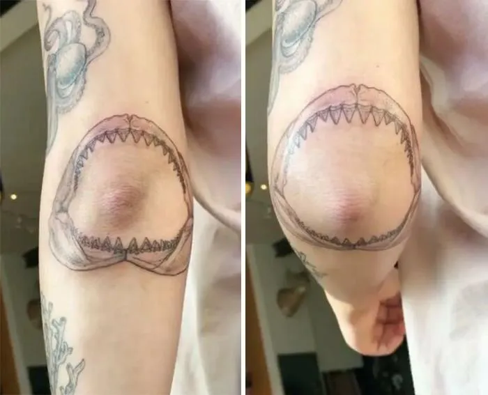Creative tattoo of a shark jaw on an elbow, transforming as the arm bends.