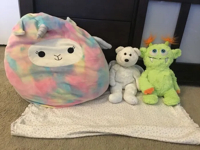 A Squish-Mello My Grandma Got Me For My B-Day My Angel Bear I Got When I Was 3 And My Monster I Won Laying On My Baby Blanket