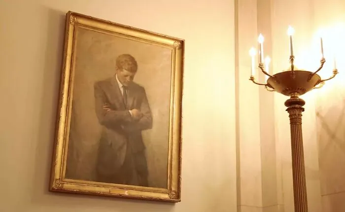 Portrait painting of a thoughtful man in a suit next to an ornate lamp, illustrating interesting facts people didn’t learn at school.