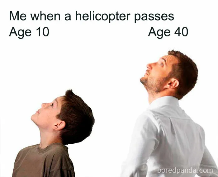Two people, a boy and a man, look up at a passing helicopter, capturing a relatable and hilarious meme moment.
