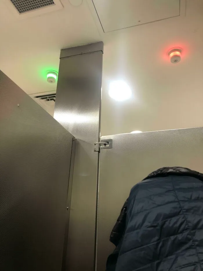The Bathroom I’m In Has Red/Green Lights Above Them To Show If The Stall Is Vacant Or Occupied