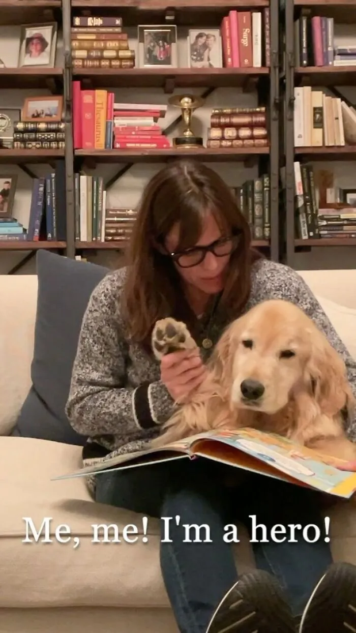 Woman reading a book with her golden retriever, showing the immense love for dogs in a cozy home setting.