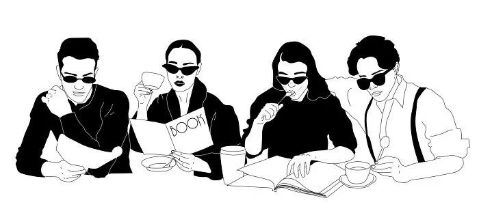 Four people in sunglasses reading and sketching at a table, embodying philosophical sketches by a tattoo artist.