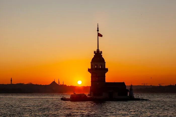 Maiden Tower Photo Taken During Sunset From The Asian Side. In The Backdrop, You Can See The Old City Silhouette Where Hagia Sophia And Blue Mosque Are Located