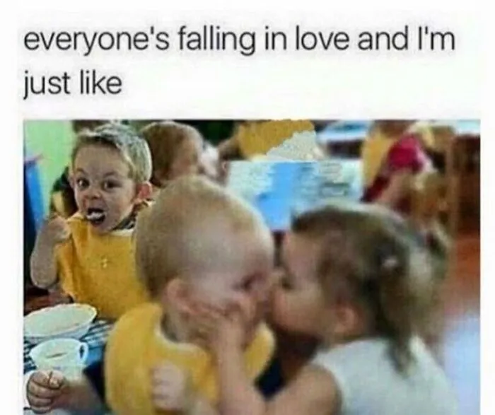 Child eating while others kiss, humorously depicting being single.