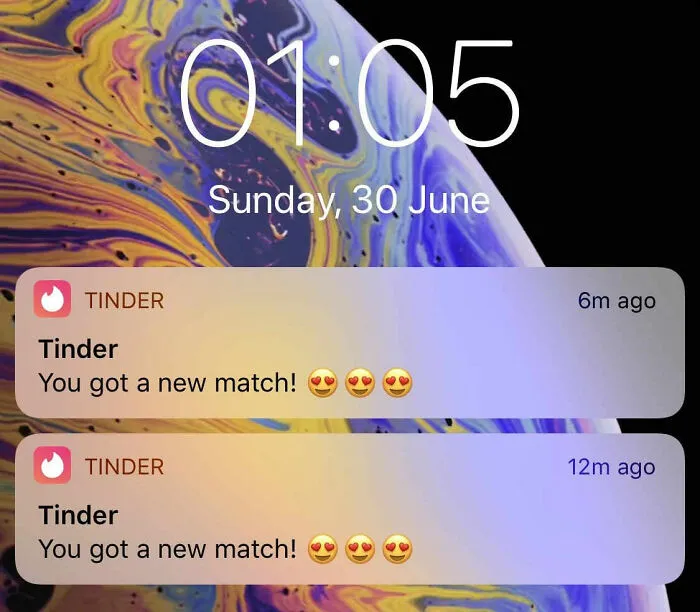 Smartphone lock screen shows Tinder notifications with new match alerts and heart emojis.