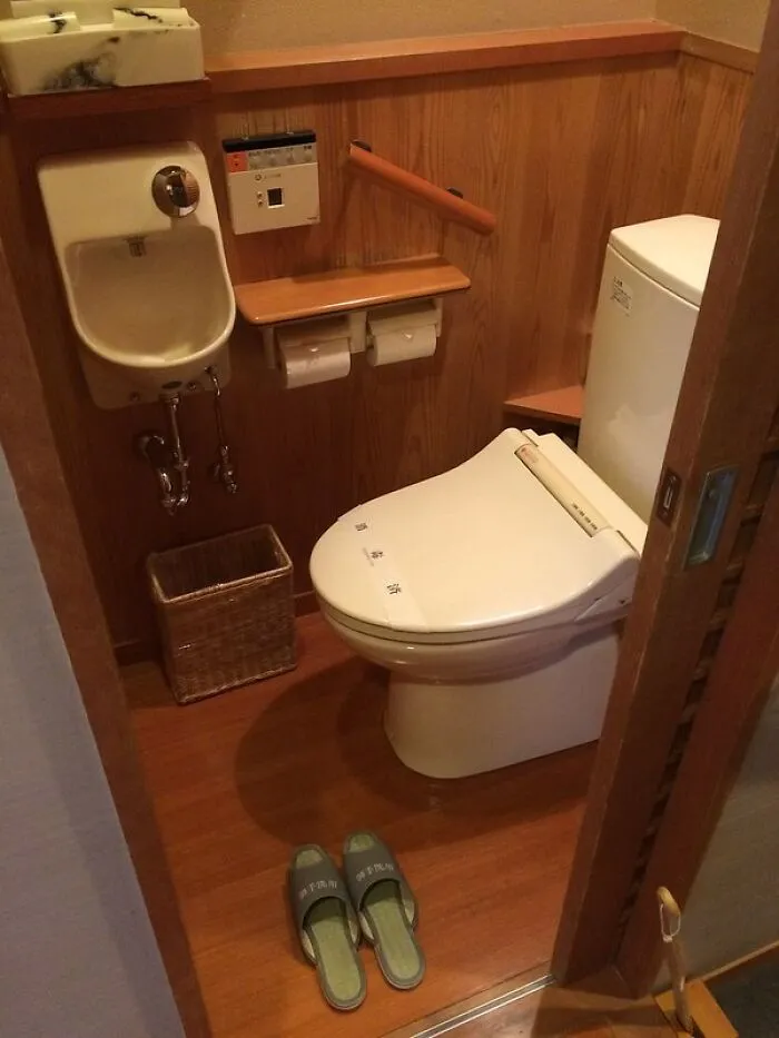 Modern Japanese toilet setup with integrated sink and control panel, showcasing unique features of Japan.