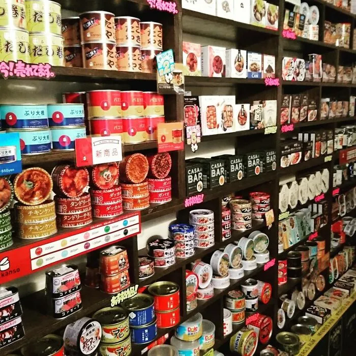 Japanese store shelves filled with a variety of canned goods, showcasing unique packaging and diverse products.