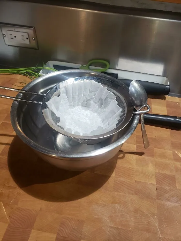 Use A Spoon To Anchor Your Strainer