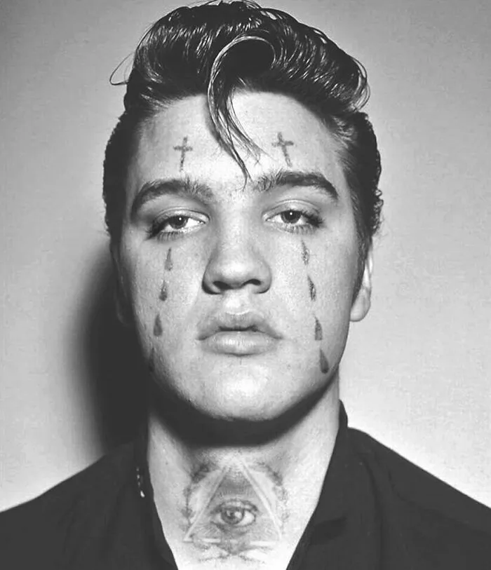 Famous person with photoshopped tattoos on face and neck, altering their iconic look.