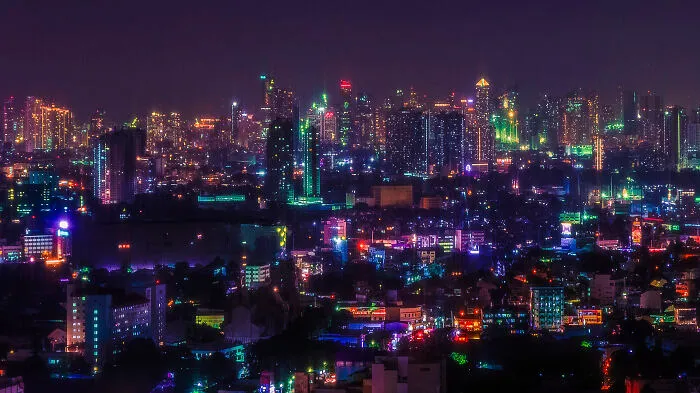 A Sprawling Aerial Cityscape Of The Metro Manila Skyline, Showing 5 Of Its Cities In One Picture
