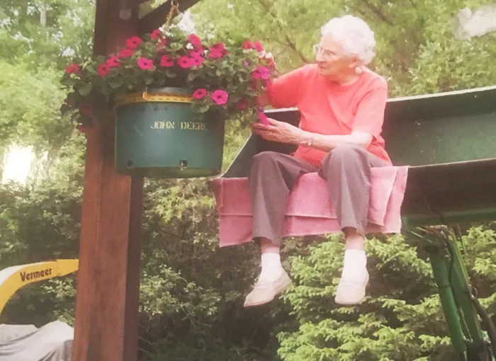 This Is My 96-Year-Old Grandma That Lives Alone And Can Walk Around Without A Cane, Walker Or Wheelchair And Who Waters Her Flowers By Being Lifted Up On A Tractor