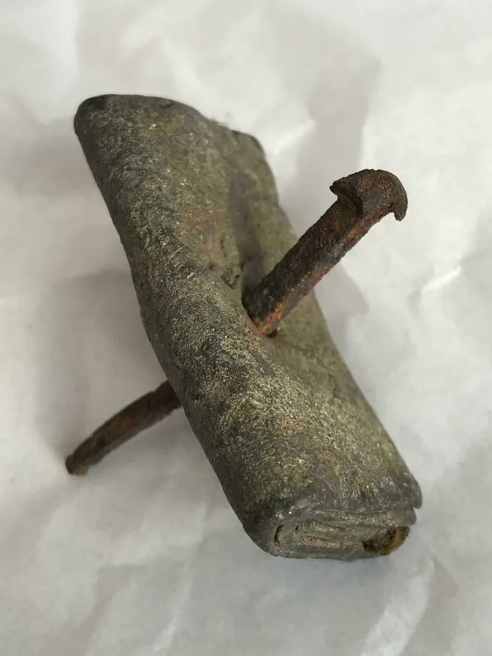 This Curio Is Known As A Curse Tablet. Curse Tablets Were Inscribed Strips Of Lead, With An Iron Nail Piercing It. They Are Typically Roman Or Grecian. This Piece Has Hair Clamped Between The Folds, Indicating That This May Be A Love Spell. Thinking To Contact A Museum On This One.