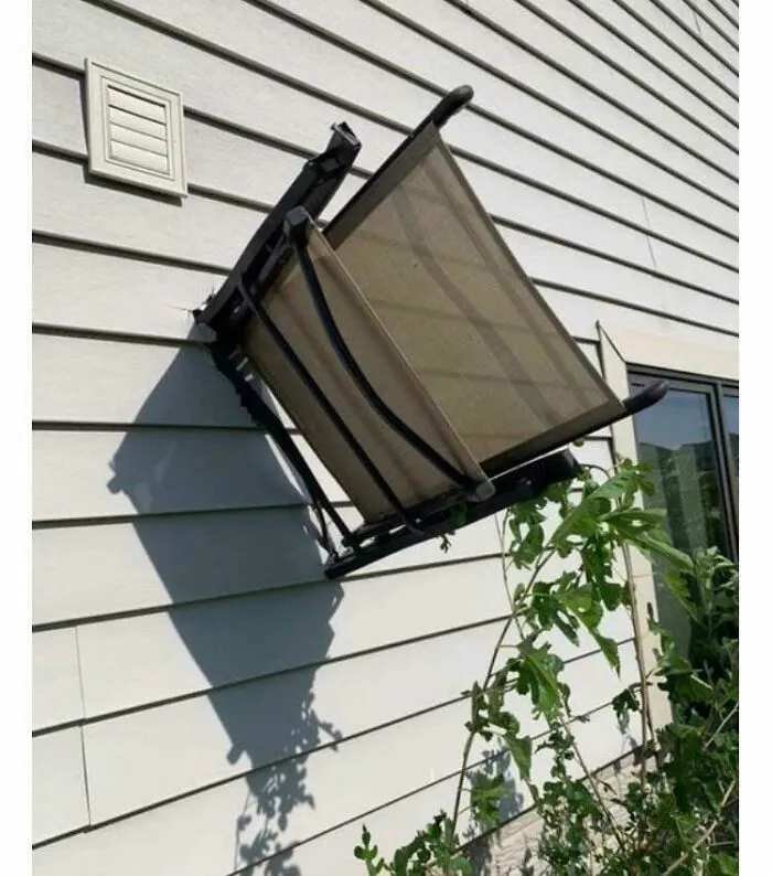 Broken outdoor chair attached to house siding, illustrating nature-made fails that make people go well that sucks.