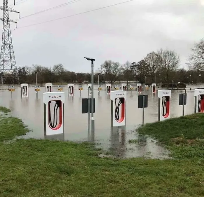 Flooded Tesla charging stations surrounded by water and grass, showing a nature mishap that makes people go well that sucks.