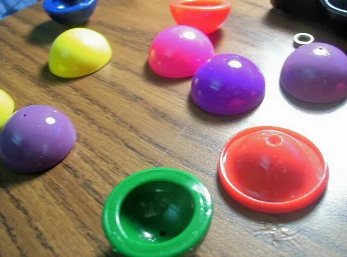 Retro toys: colorful plastic poppers on a wooden table, reminiscent of the '70s, '80s, and '90s childhood games.