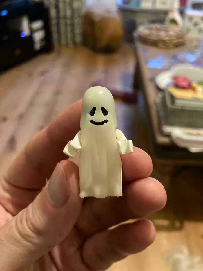 Retro toy ghost figurine from the '70s, '80s, or '90s held in hand, nostalgic childhood memories.