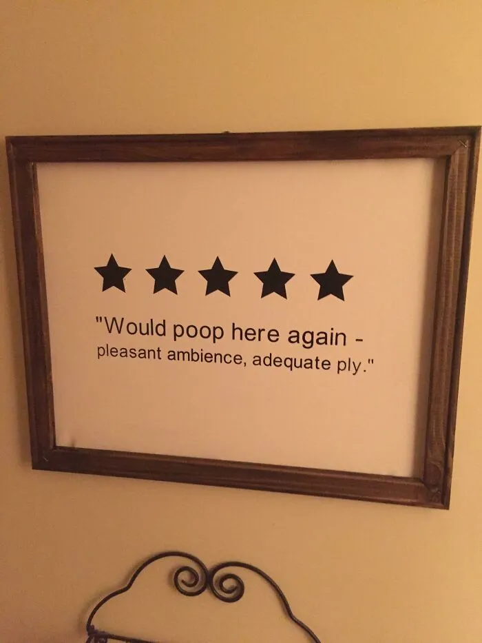 Funny sign with five stars, humorously reviewing restroom experience: "Would poop here again - pleasant ambience, adequate ply."
