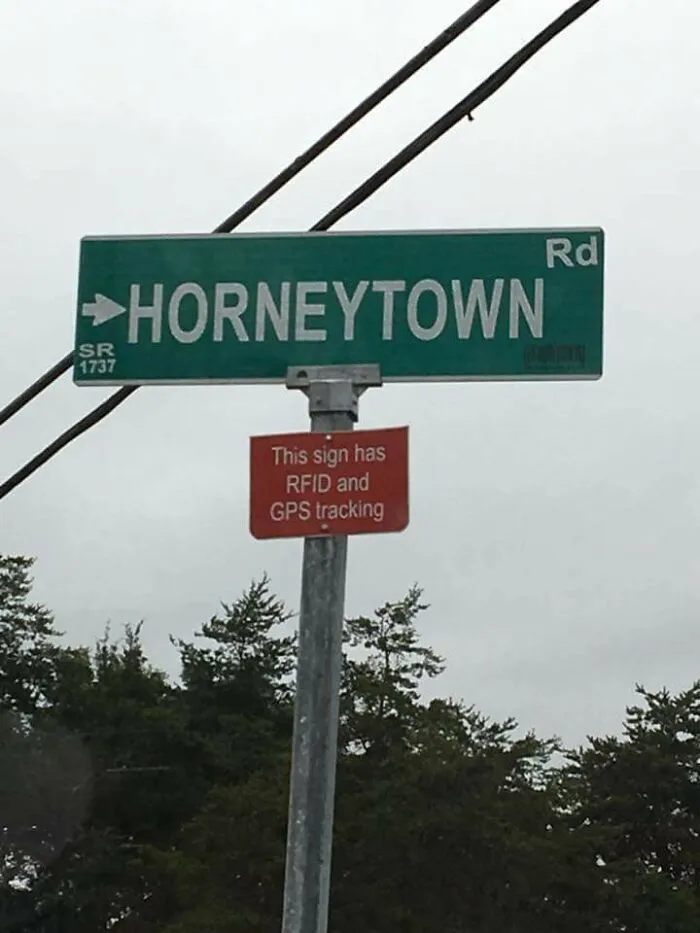 Funny road sign for Horneytown Road with RFID and GPS tracking notice.