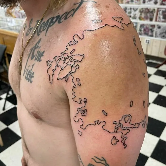 Tattoo artist covers shoulder scars with outline design, highlighting transformation and creativity.