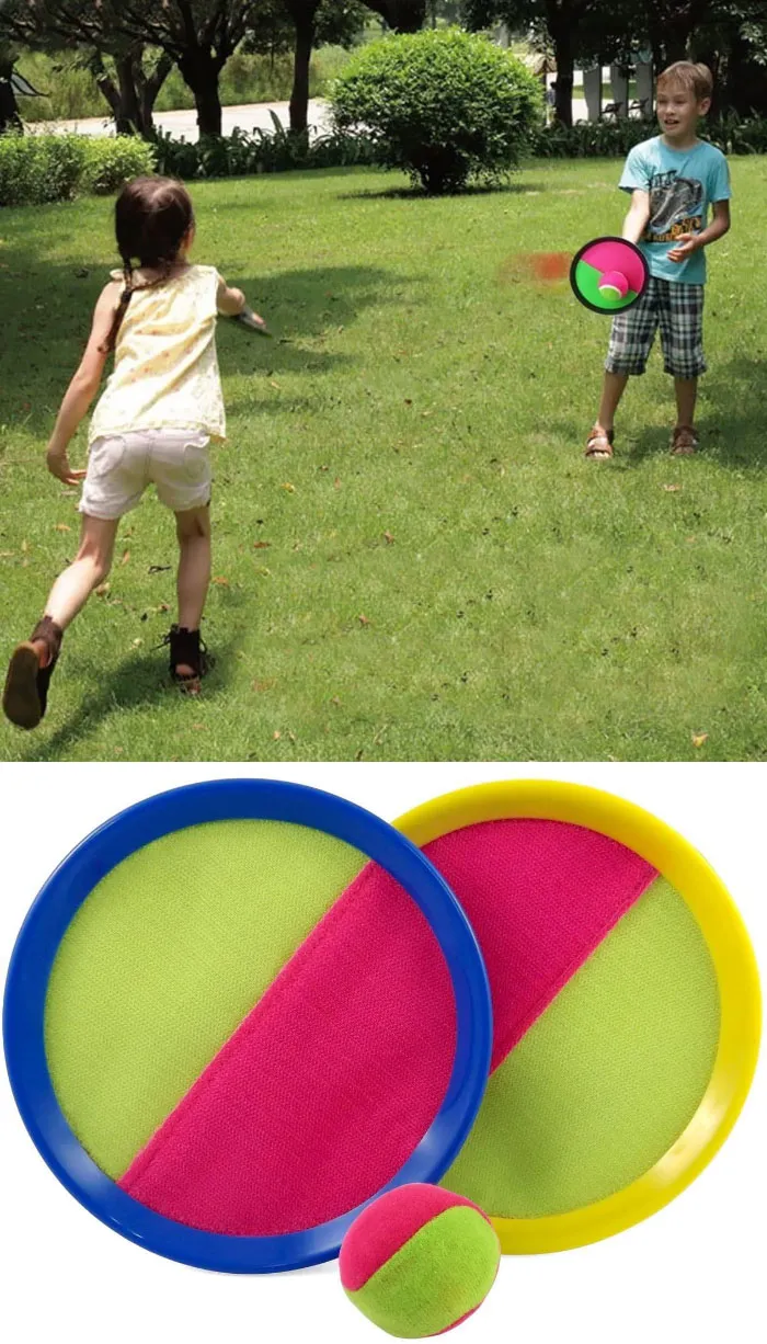 Children playing with Velcro catch toys, popular toys from the '70s, '80s, and '90s, on a grassy field.