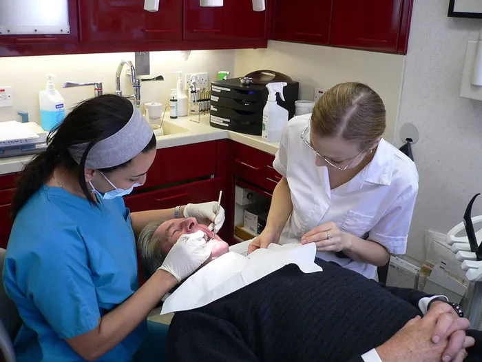 Dentist and assistant treating a patient in a clinic, illustrating not-so-fun facts people in this online group can’t forget.